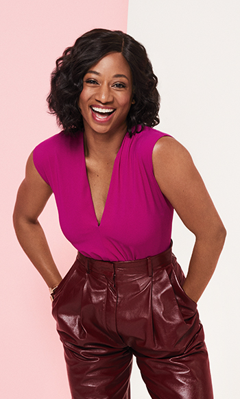 A picture of Monique Coleman, a black female entrepreneur and philanthropist, wearing a pink shirt