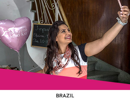 Mary Kay Independent Beauty Consultants giving students makeovers and makeup tutorials during Global Day of Beauty in Brazil.