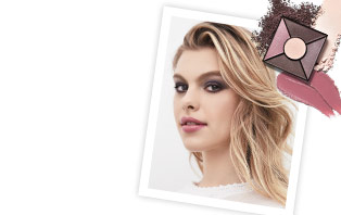 Get the steps to achieving the hottest looks of the season using the new color collection from Mary Kay. In the right corner, a white photo frame shows a young woman wearing a purple smoky eye and a pink lip. Above the upper right corner is the new Limited-Edition Eye Palette in Rose Nudes.