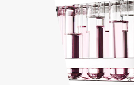 Beakers filled with light pink liquid are shown to represent Mary Kay’s research and development in cosmetics.